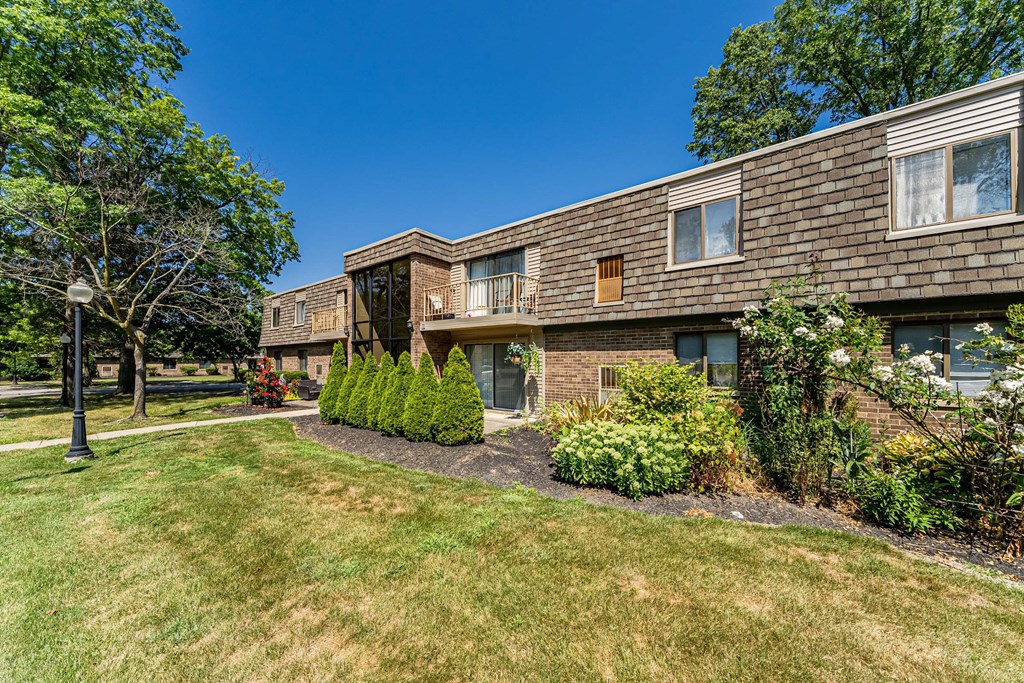 A building with a green lawn in front of it.