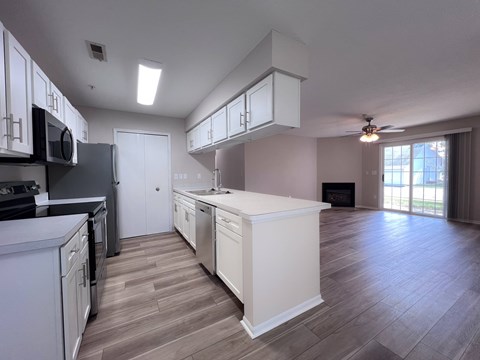 A modern kitchen with white cabinets and a large island.