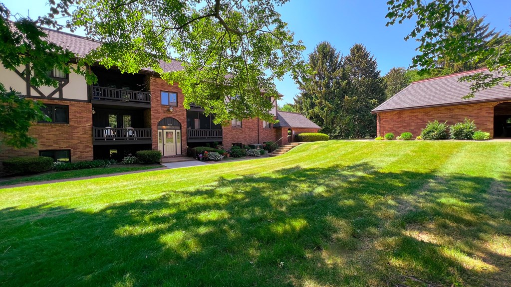 a large grassy area with a building in the background