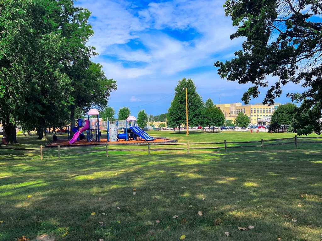 A playground with a slide and a purple slide.