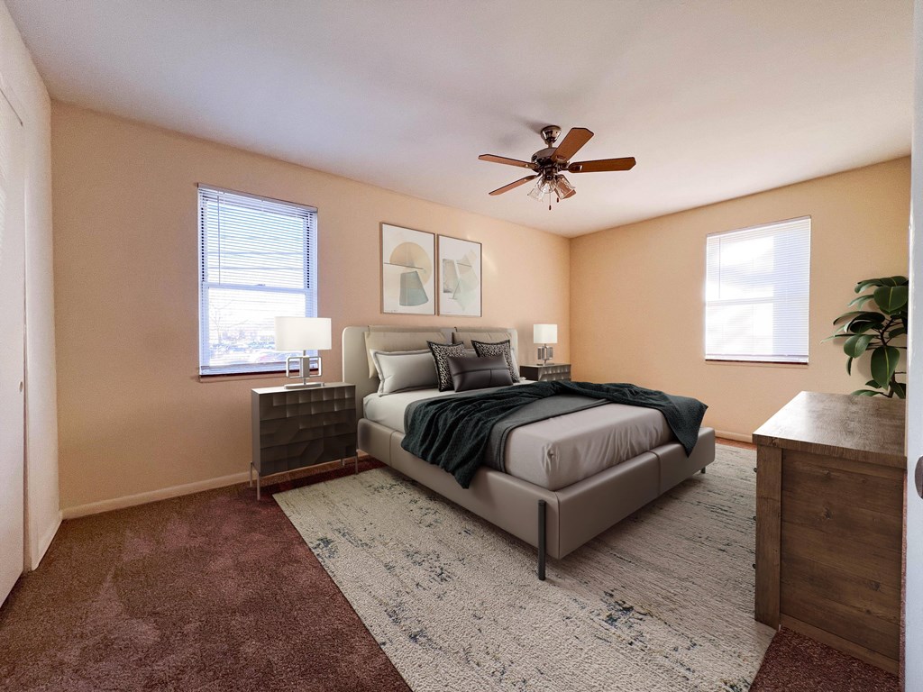 a bedroom with a bed and a ceiling fan
