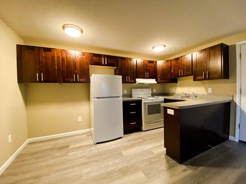 a kitchen with wooden cabinets and a white refrigerator