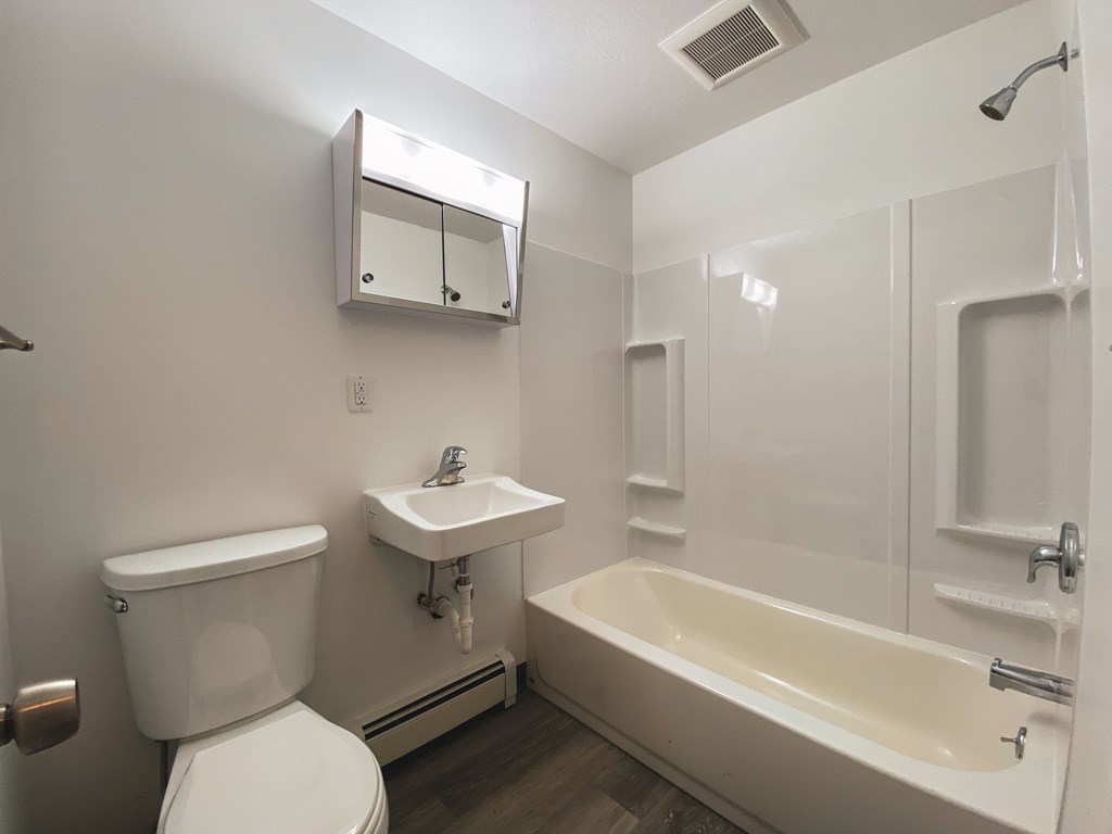 an empty bathroom with a toilet sink and tub