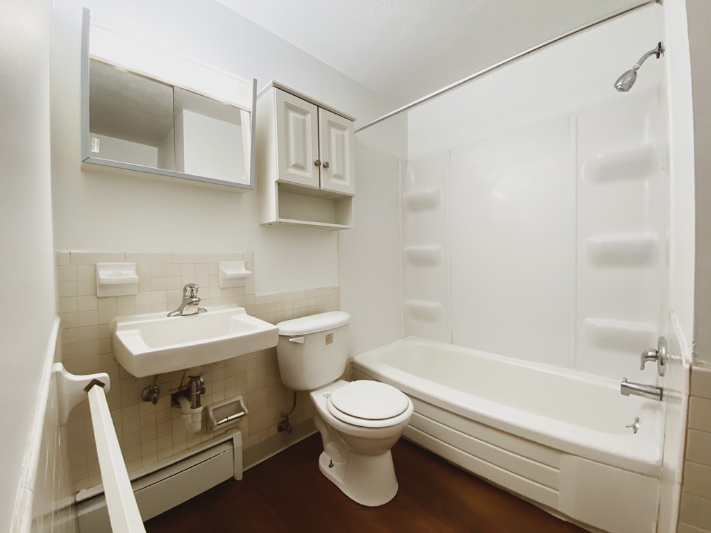 a bathroom with a toilet and a sink and a bath tub