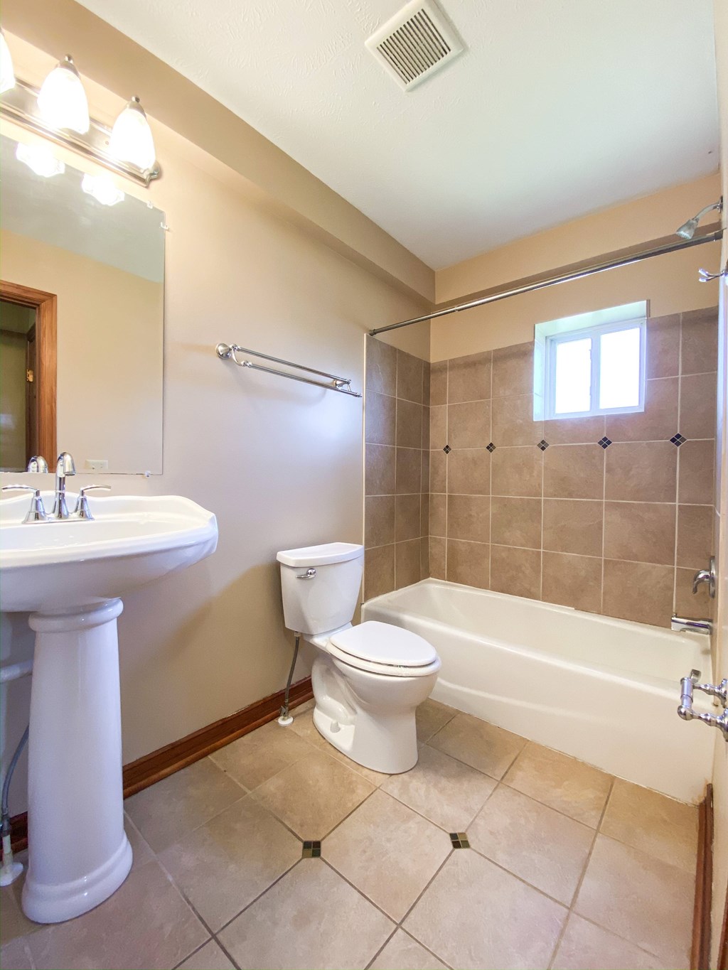 a bathroom with a toilet and a sink and a bath tub at Hallwood Manor Apartments, Mentor, OH
