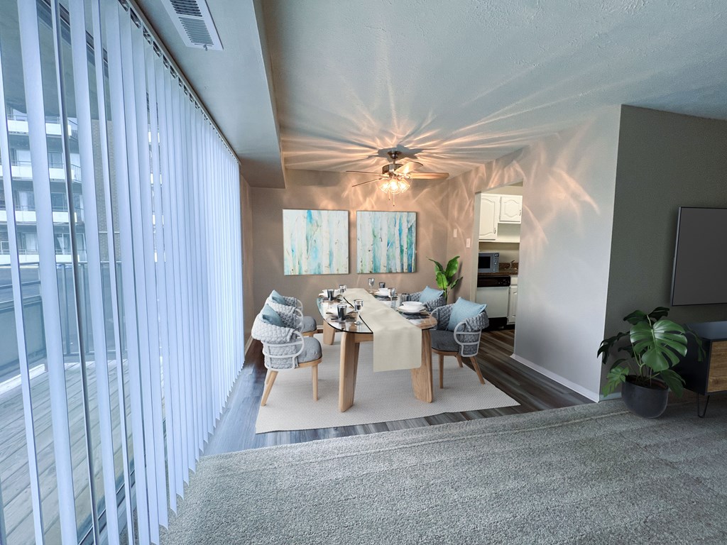 a dining room with a table and chairs and a ceiling fan