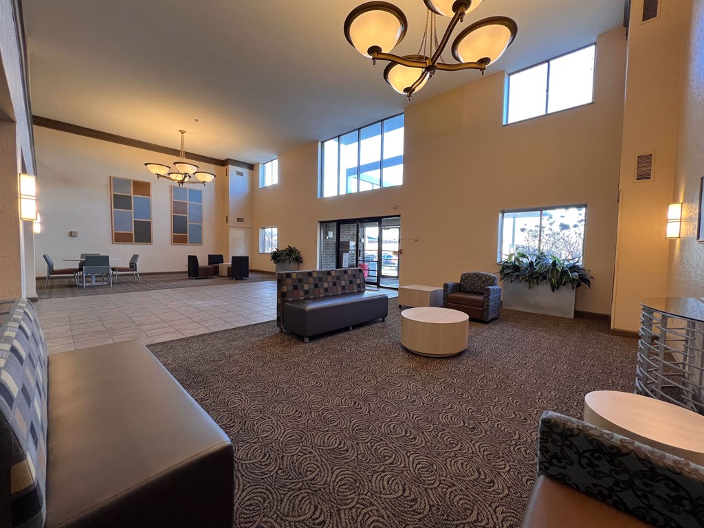 a large lobby with couches and chairs and a chandelier