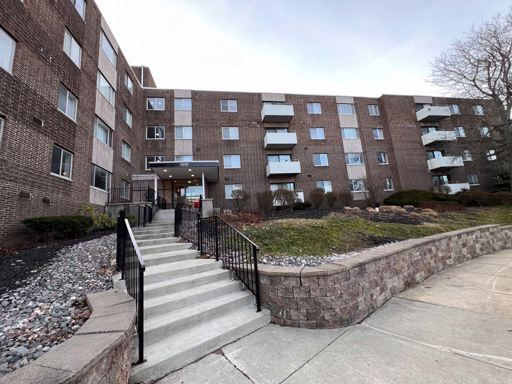 a large brick building with stairs in front of it