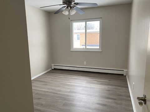 Bright Bedroom with hardwood floors and a ceiling fan at Cedarwood Estates Apartments, Willoughby, OH, Ohio