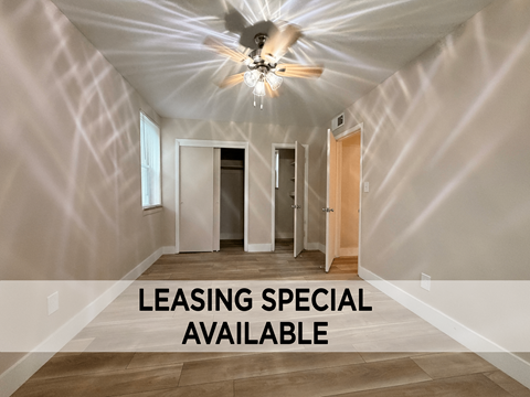 A room with a ceiling fan and a sign that says "LEASING SPECIAL AVAILABLE".