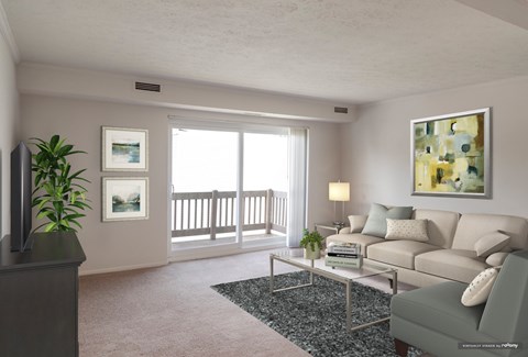 A living room with a grey couch, a coffee table, and a painting on the wall.