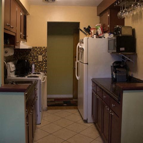 a kitchen with a refrigerator and a stove