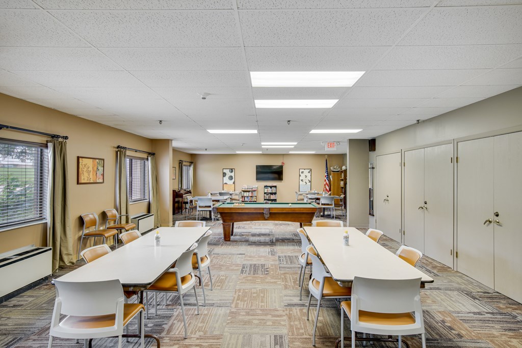 A conference room with a long table and chairs at Independence Place Apartments, Parma Heights, Ohio
