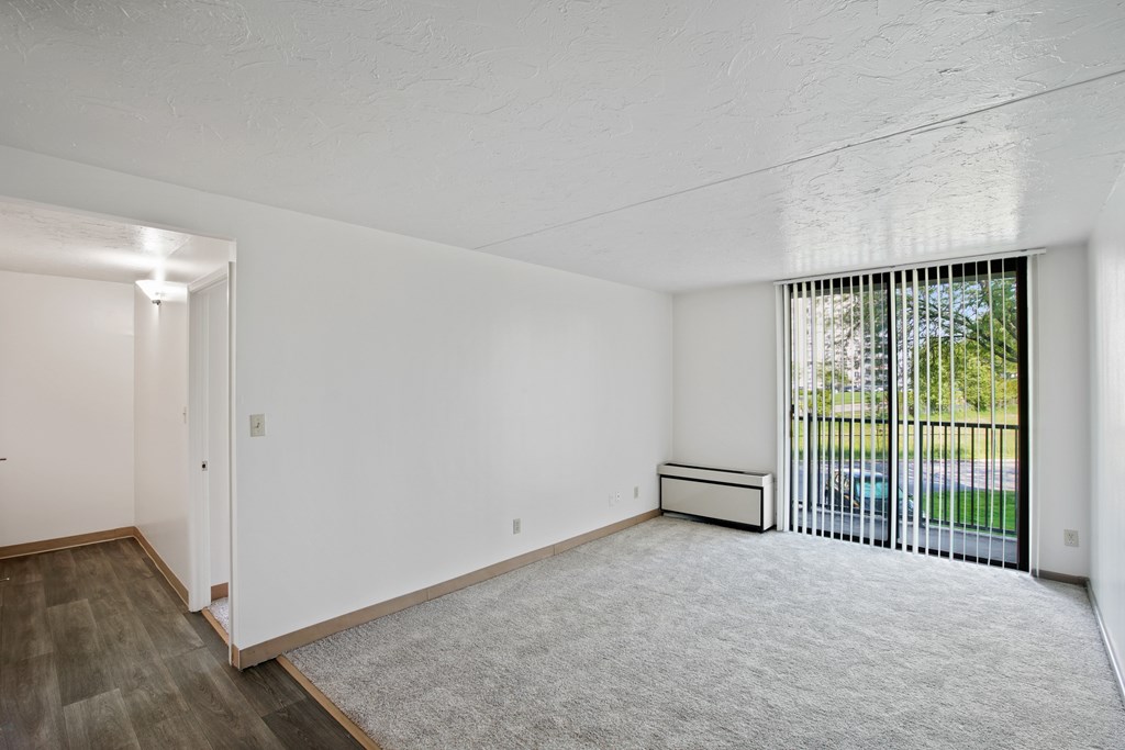 A room with white walls and a window with blinds at Independence Place Apartments, Parma Heights, 44130