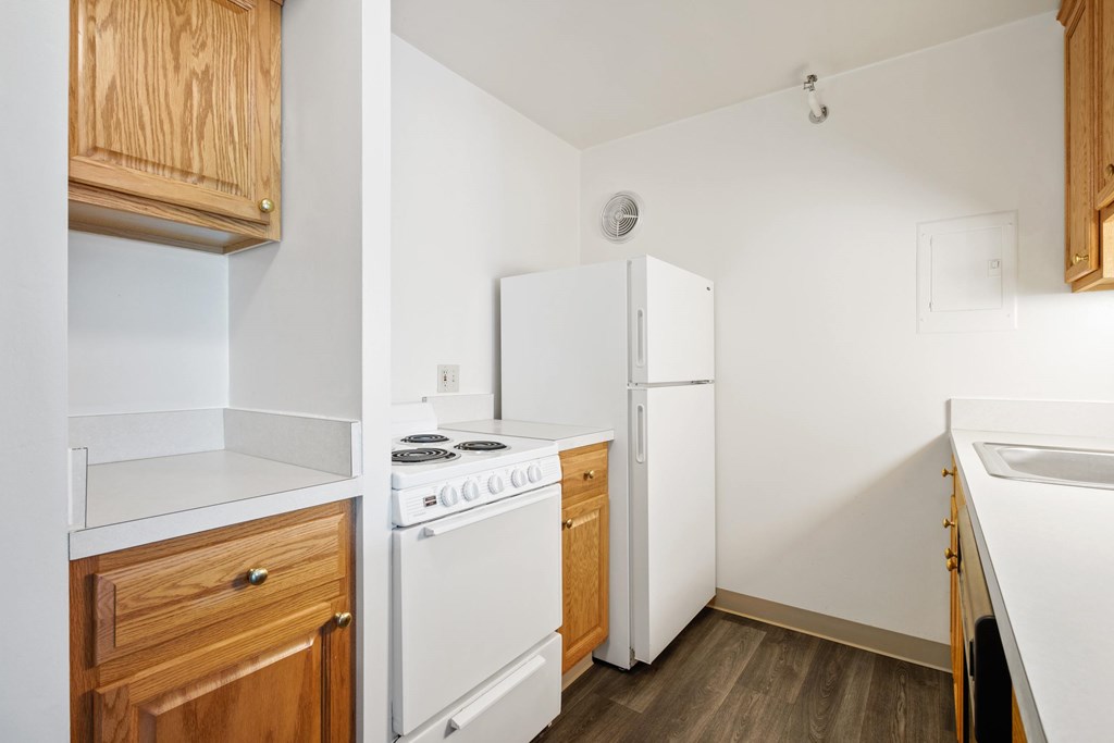 A kitchen with a white stove and white refrigerator at Independence Place Apartments, Parma Heights, OH