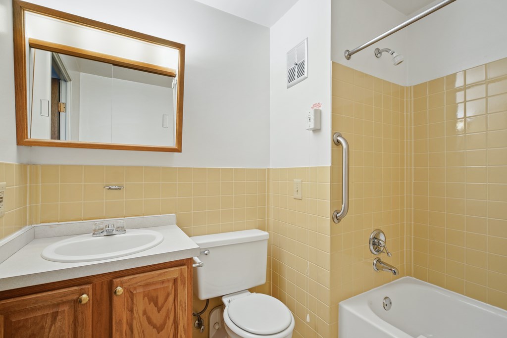 A bathroom with a toilet, sink, and bathtub at Independence Place Apartments, Ohio 44130