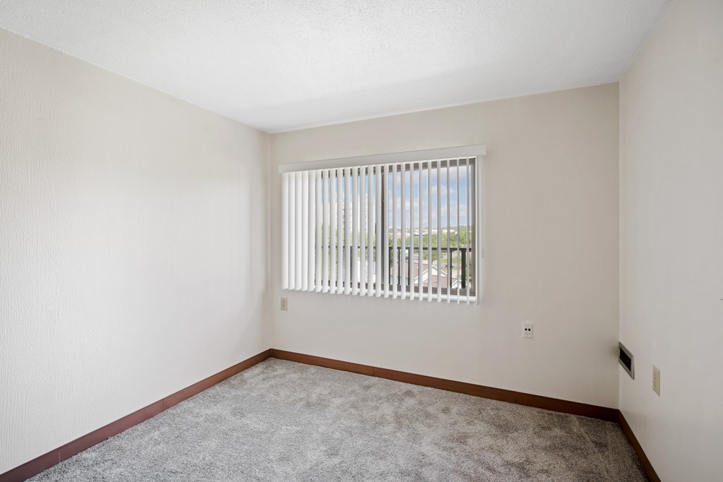 A room with a window covered by white blinds at Independence Place Apartments, Parma Heights, OH