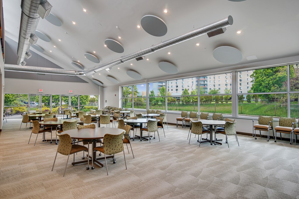 A room with tables and chairs and a lot of windows at Independence Place Apartments, Ohio