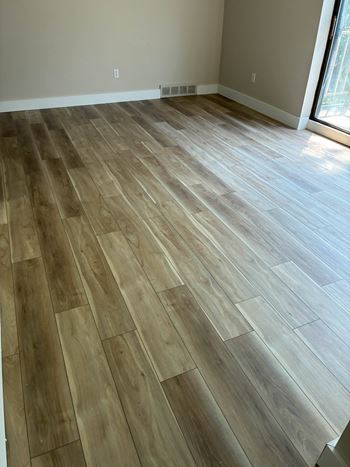 A room with a wooden floor and a window.