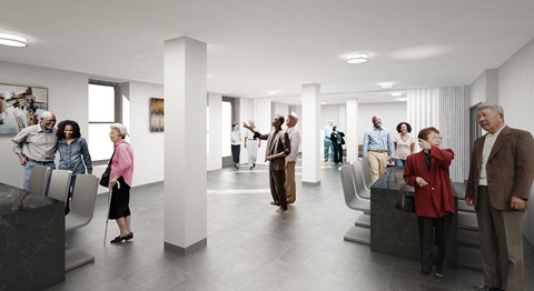 A group of people are standing in a modern hallway.