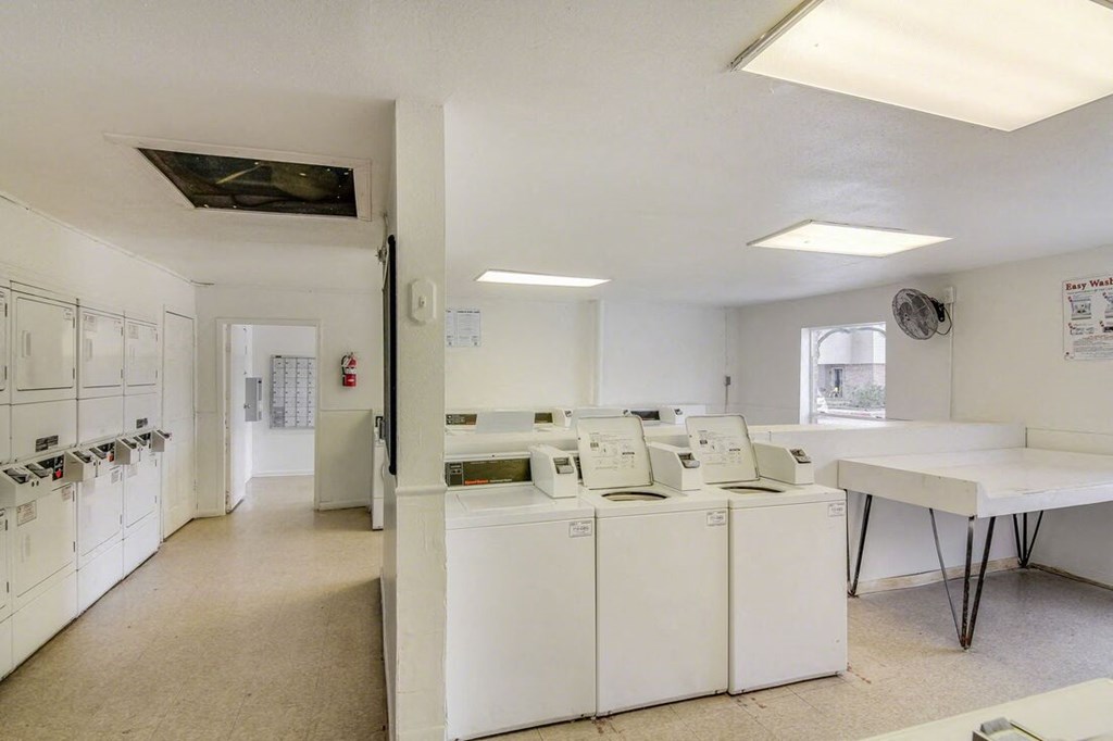 a laundry room filled with washers and dryers