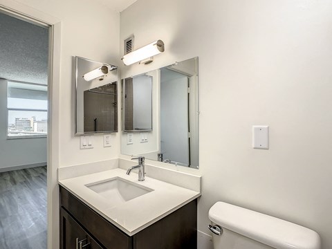 a bathroom with a toilet sink and mirror