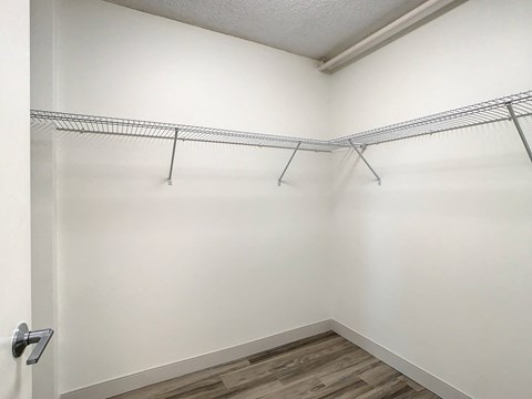 an empty room with white walls and a wooden floor