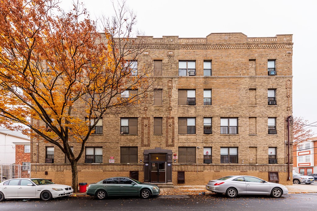 a brick building with a tree in front of it
