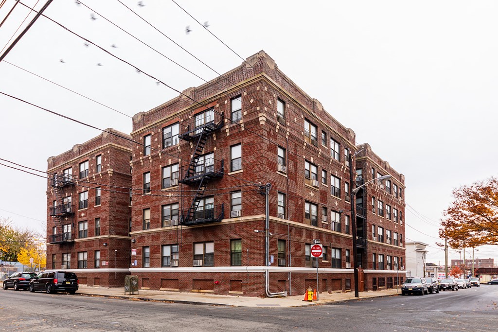a red brick apartment building on a city street