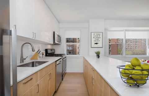 a kitchen with wooden cabinets and a sink and a window