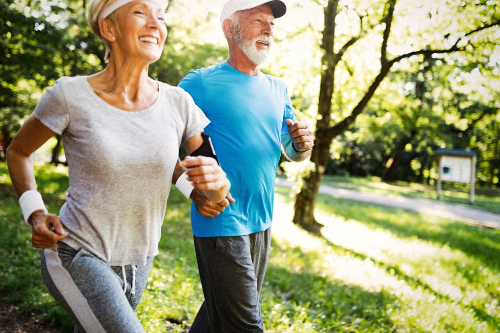 a man and woman running in the park