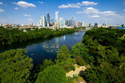 an aerial view of a river with a city skyline in the background