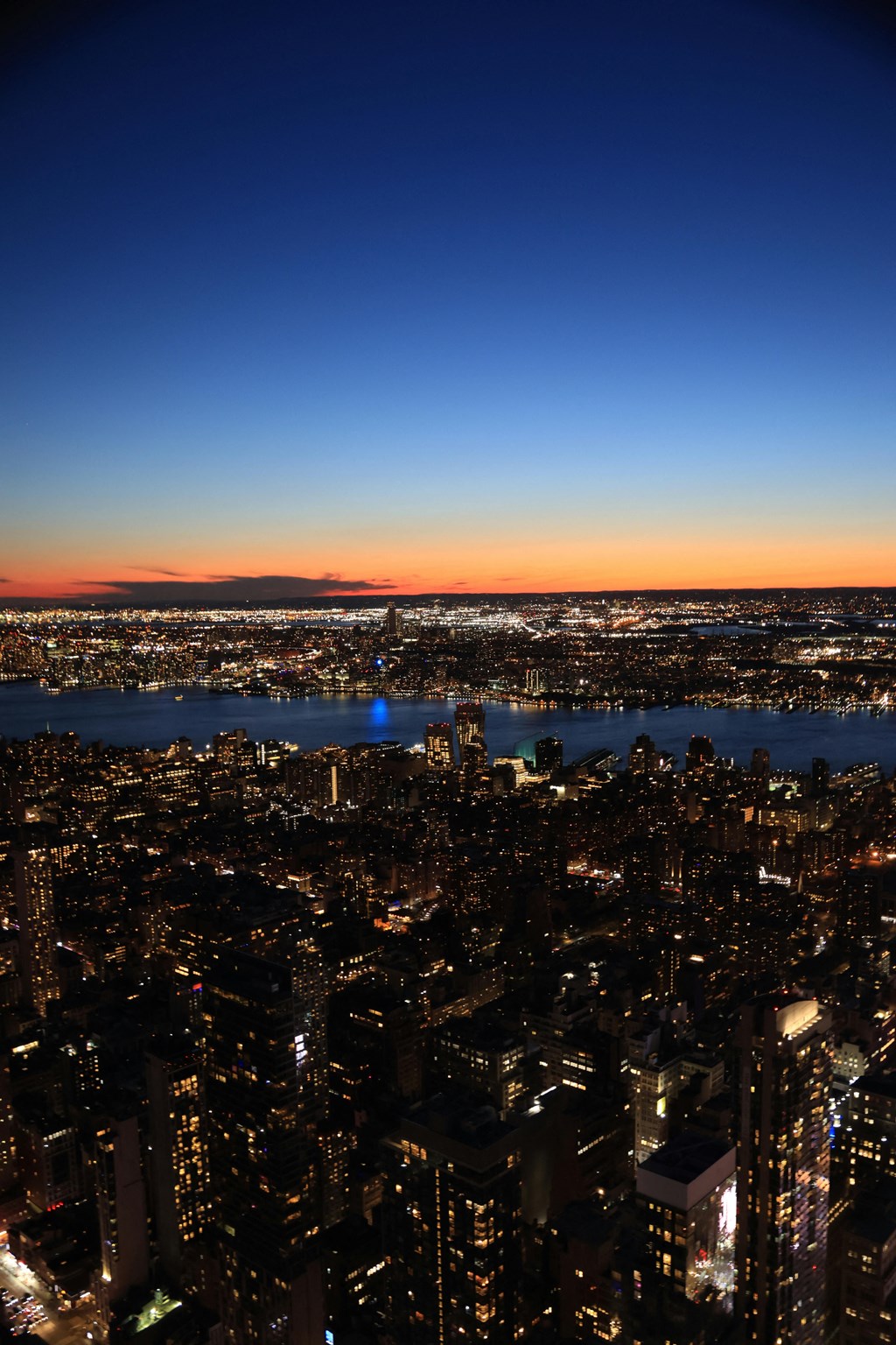 a view of the city at night from the top of the empire state building