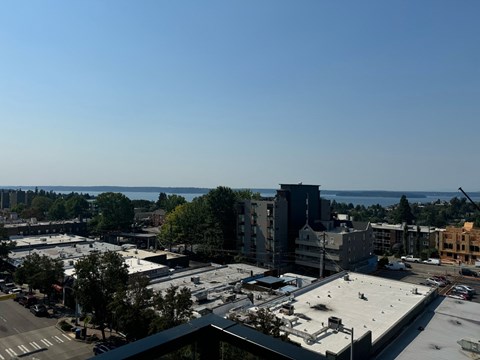 an aerial view of a city with a body of water in the background at Junction Central, Seattle Washington
