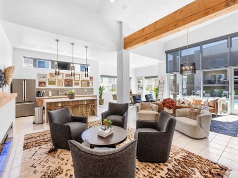 A modern living room with a dining table and grey chairs.