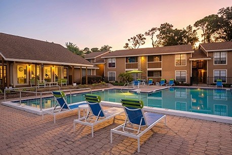 A poolside area with lounge chairs and a swimming pool.