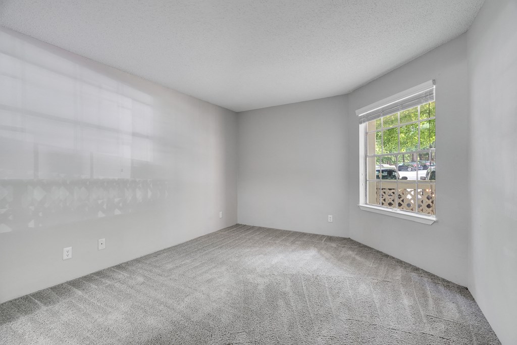 Bedroom With Large Window Overlooking The Patio