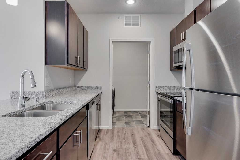 Kitchen Featuring Granite Countertops & Stainless Steel Appliances