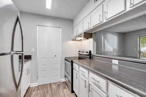 the kitchen in a new home with white cabinets and stainless steel appliances