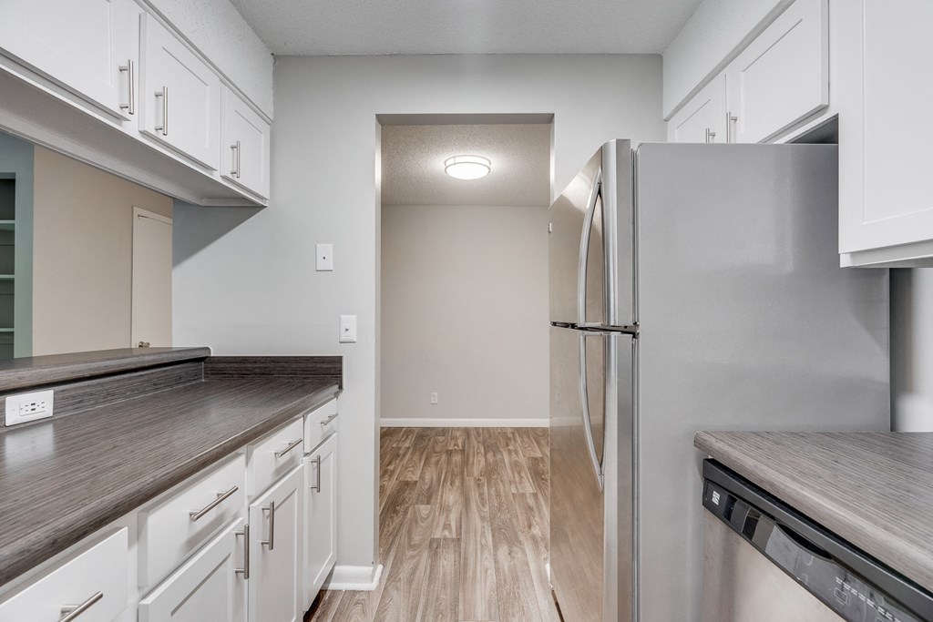 Kitchen With Stainless Steel Appliances & Wood-Style Flooring