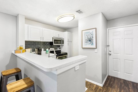 a kitchen with a counter top and a microwave