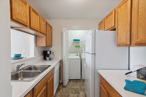 a kitchen with white appliances and wooden cabinets
