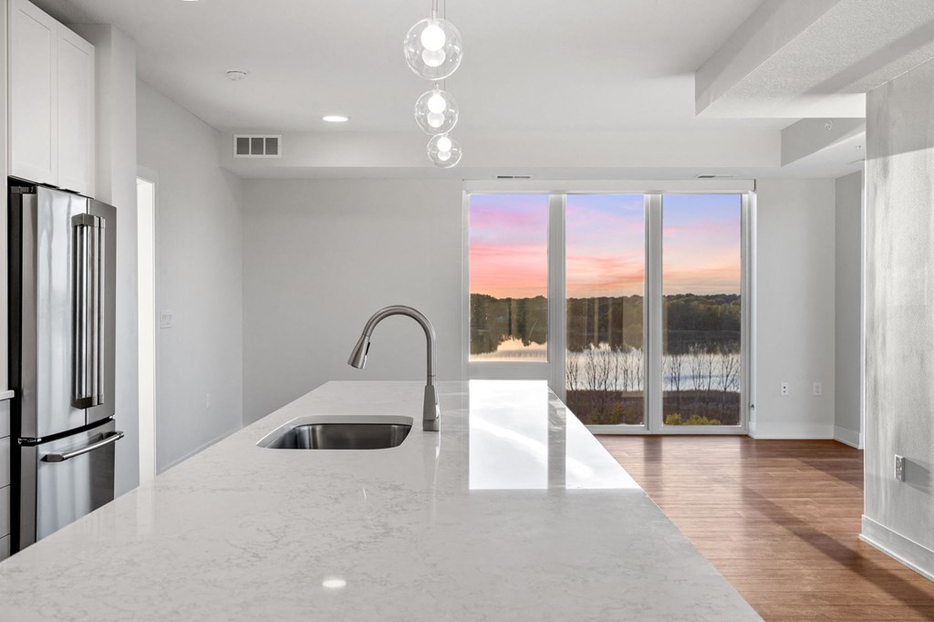 Expansive Kitchen Island with Overhead Lighting