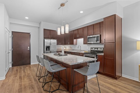 A kitchen with a table and chairs in the middle of it.