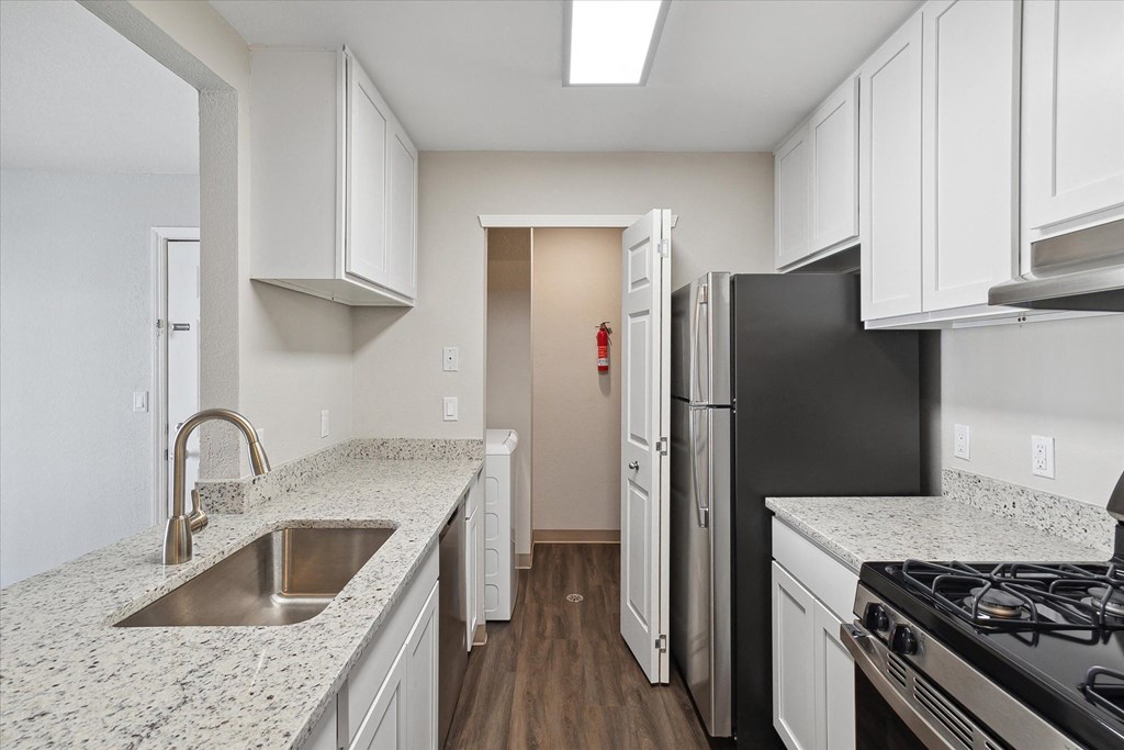 Kitchen with White Cabinetry and Stainless Steel Appliances
