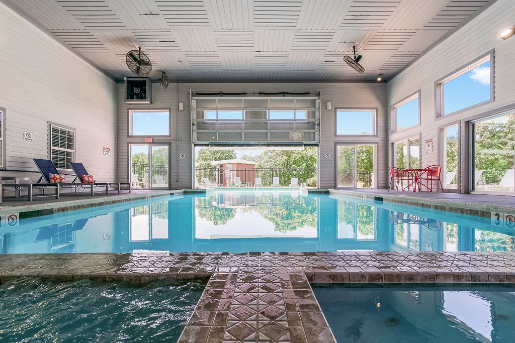 Indoor & Outdoor Pool Area With Garage Door That Goes Up