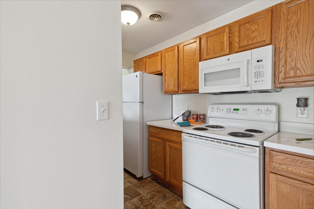 Kitchen with White Appliances and Wood Cabinetry