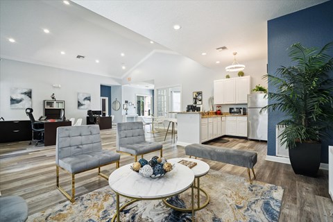 A modern living room with a white coffee table and grey chairs.