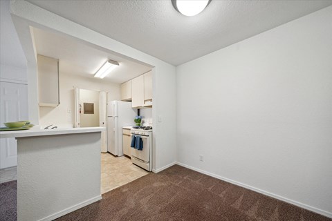a kitchen with white appliances and a counter top