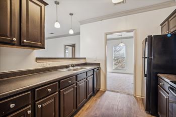 Kitchen with Dark Brown Cabinetry and Stainless Steel Appliances